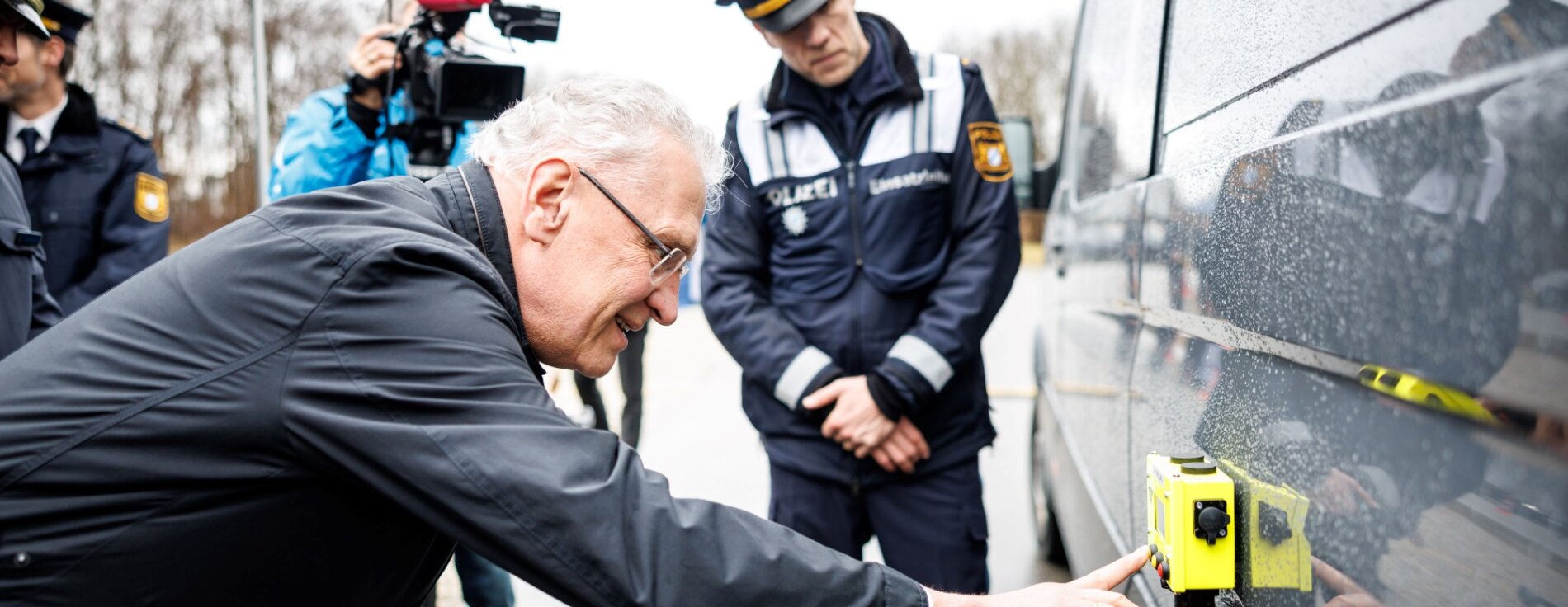 8. Februar 2024: Mehr Schleuserdelikte, illegale Migration und grenzüberschreitende Kriminalität auf hohem Niveau – so hat Innenminister Joachim Herrmann heute die Jahresbilanz 2023 der Bayerischen Grenzpolizei zusammengefasst. „Unsere Grenzfahnder hatten im vergangenen Jahr bei der Schleierfahndung und den unmittelbaren Grenzkontrollen wieder alle Hände voll zu tun. Die Bayerische Grenzpolizei ist wichtiger denn je, um für mehr Sicherheit zu sorgen“, betonte Herrmann. Derzeit testet die Bayerische Grenzpolizei innovative Personendetektionsgeräte, die über den Herzschlag beispielsweise auf Ladeflächen versteckte Personen erkennen können. Herrmann testet gelbes elektronisches Gerät an einem Kastenwagen